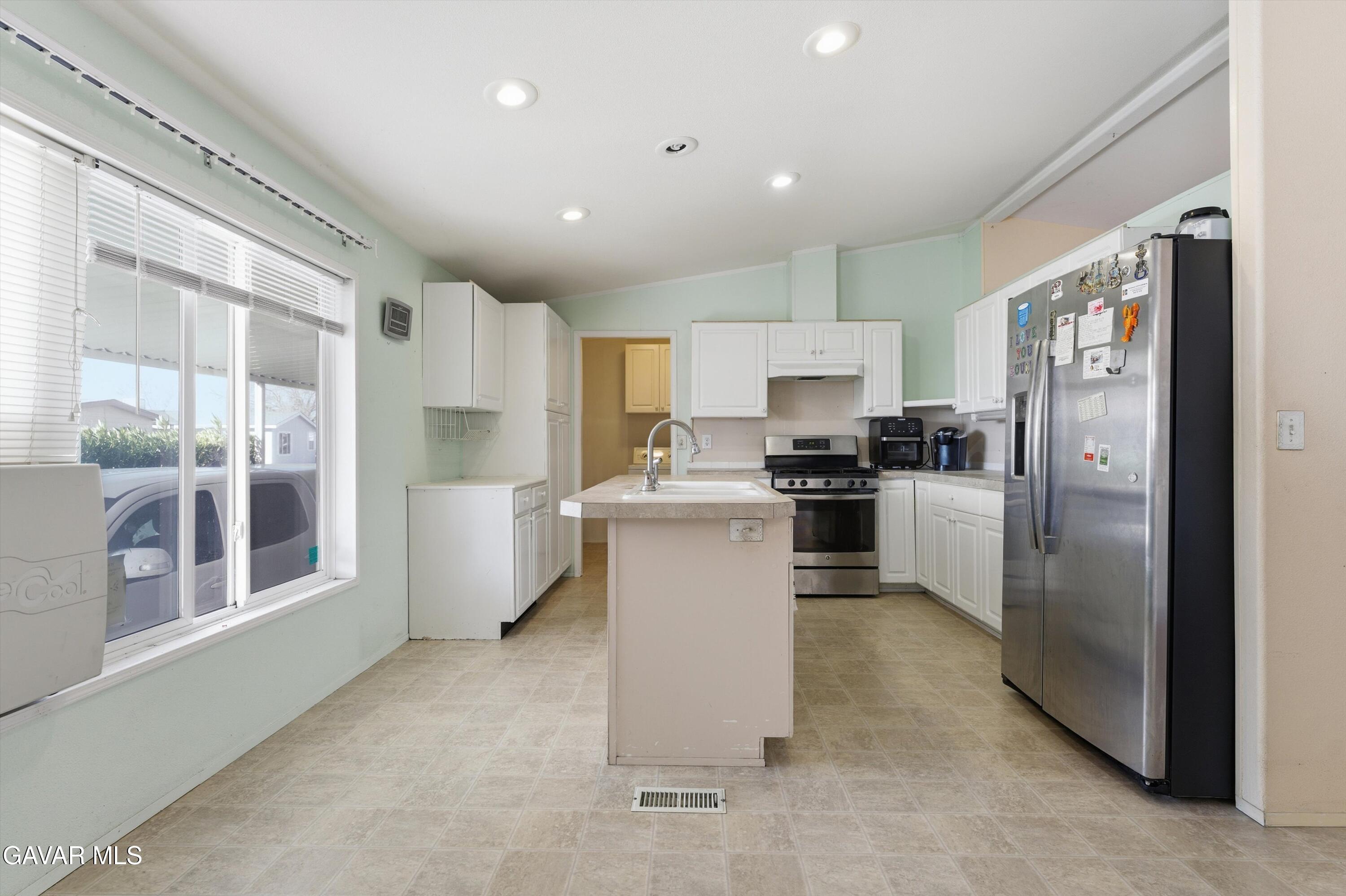 1900 Sandra Way Rosamond, CA 93560 - Photo 7 of 20 a kitchen with a refrigerator and a sink