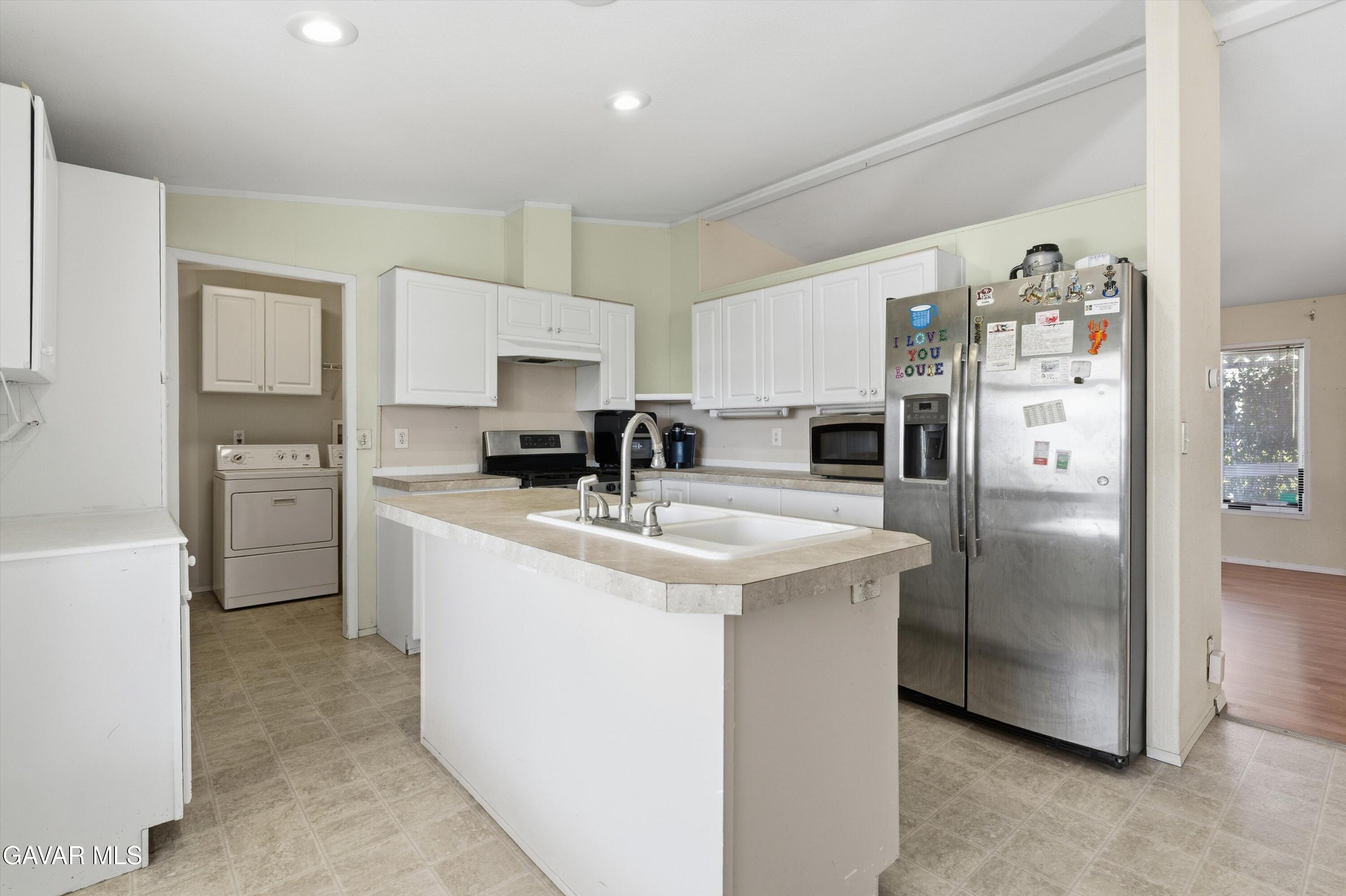 1900 Sandra Way Rosamond, CA 93560 - Photo 8 of 20 a kitchen with stainless steel appliances granite countertop a refrigerator a sink a stove a microwave a counter space and cabinets