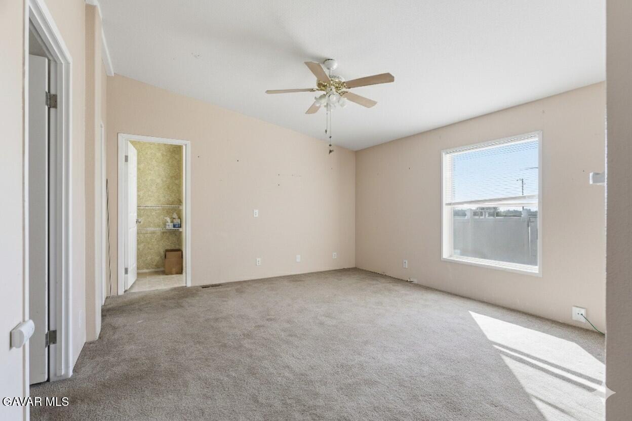 1900 Sandra Way Rosamond, CA 93560 - Photo 9 of 20 an empty room with a window and a ceiling fan