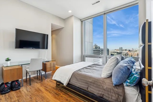 a bedroom with a bed and a flat screen tv