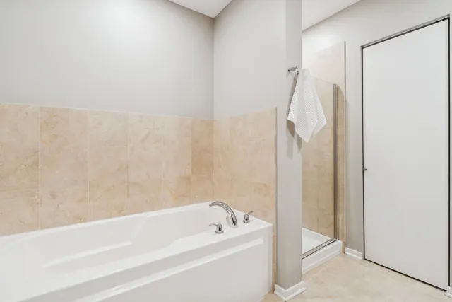 a bathroom with a tub a sink and a shower