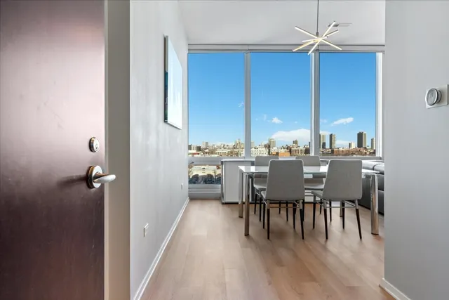 a dining room with furniture window and wooden floor