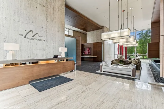 a large living room with stainless steel appliances kitchen island granite countertop furniture and a fireplace