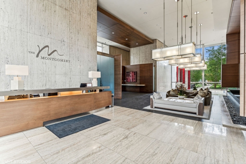 500 West Superior Street, Unit 802 Chicago, IL 60654 - Photo 21 of 28 a large living room with stainless steel appliances kitchen island granite countertop furniture and a fireplace
