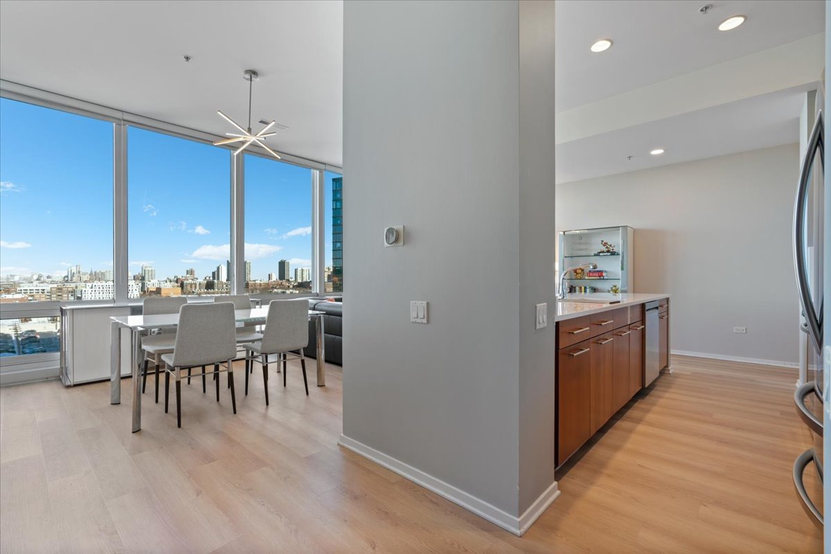 500 West Superior Street, Unit 802 Chicago, IL 60654 - Photo 3 of 28 a open kitchen with a table and chairs
