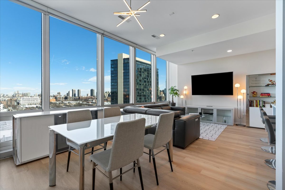 500 West Superior Street, Unit 802 Chicago, IL 60654 - Photo 4 of 28 a view of a dining room with furniture window and wooden floor