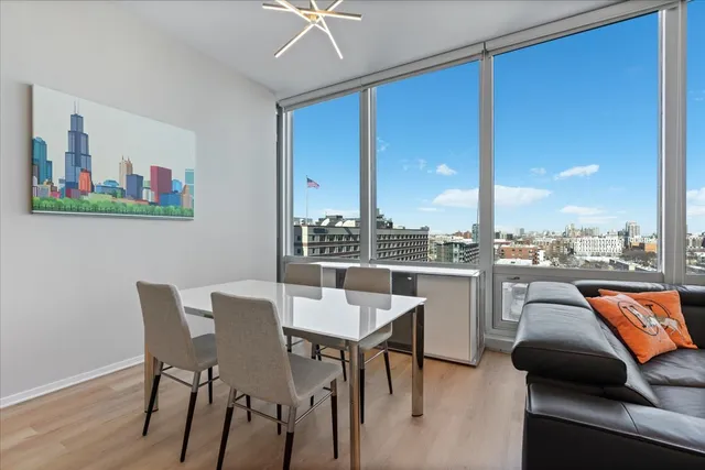 a living room with furniture a rug and a floor to ceiling window