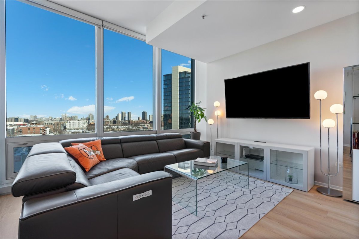 500 West Superior Street, Unit 802 Chicago, IL 60654 - Photo 8 of 28 a living room with furniture and a flat screen tv