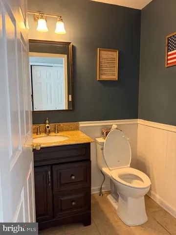 a bathroom with a toilet a sink and mirror