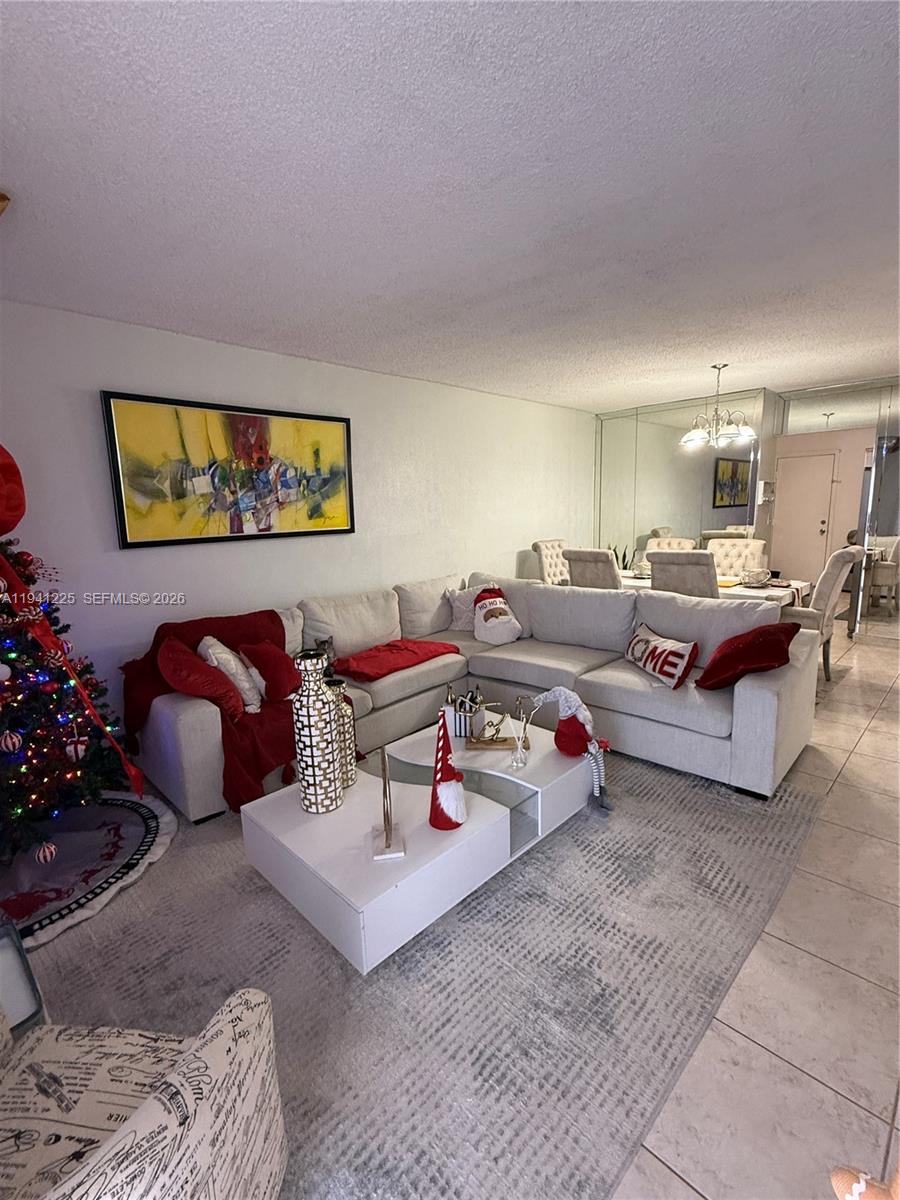 a living room with furniture rug and flowers