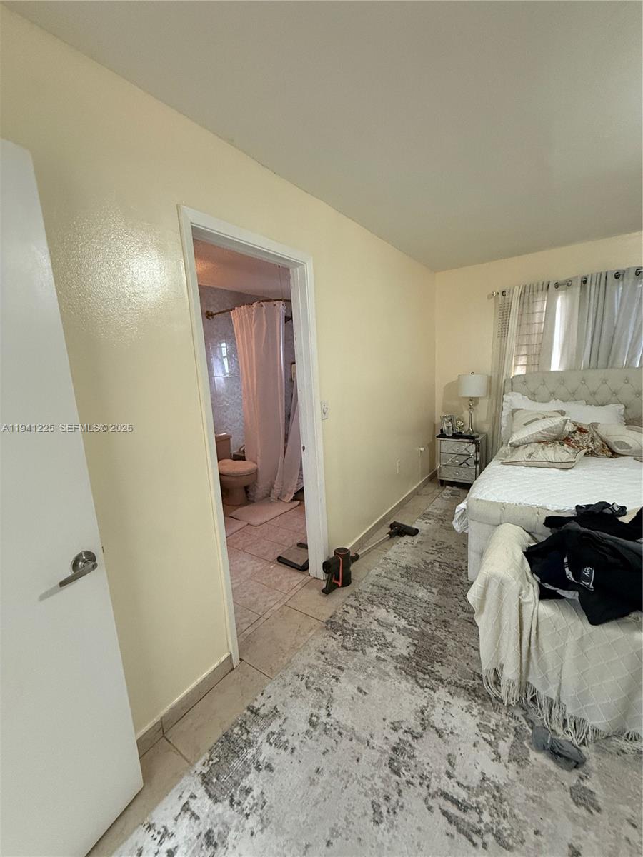 1950 West 54th Street, Unit 409 Hialeah, FL 33012 - Photo 15 of 26 a bedroom with a bed and a window