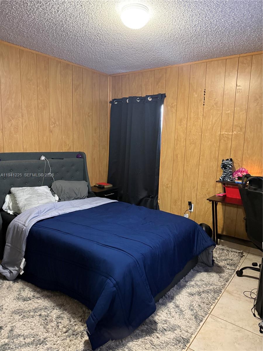 1950 West 54th Street, Unit 409 Hialeah, FL 33012 - Photo 20 of 26 a bedroom with a bed and a window