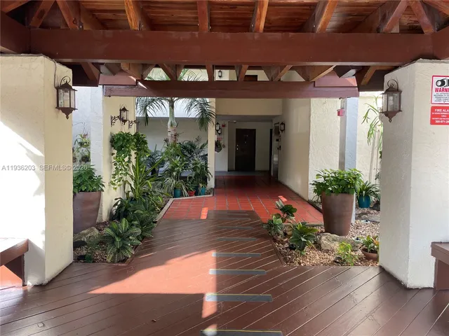 a view of a building with potted plants