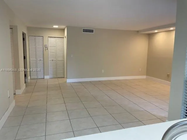 a view of an empty room and staircase