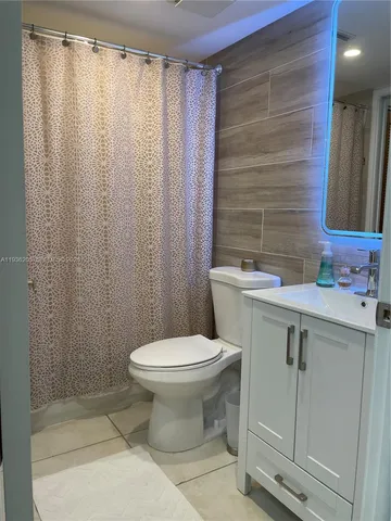 a bathroom with a toilet a sink and bathtub