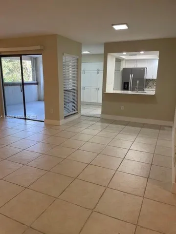 a view of a kitchen with a sink and stainless steel appliances