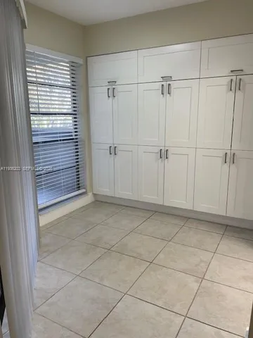 a kitchen with granite countertop a stove microwave and refrigerator