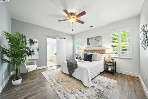 a view of a backyard with a barbeque and wooden fence