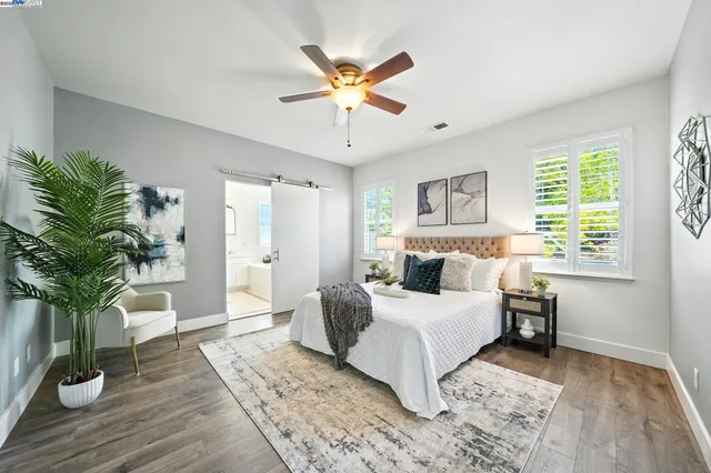 a view of a backyard with a barbeque and wooden fence