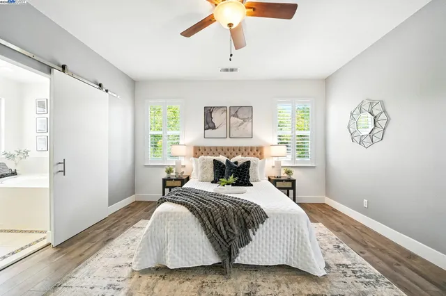 an aerial view of residential houses with outdoor space and trees