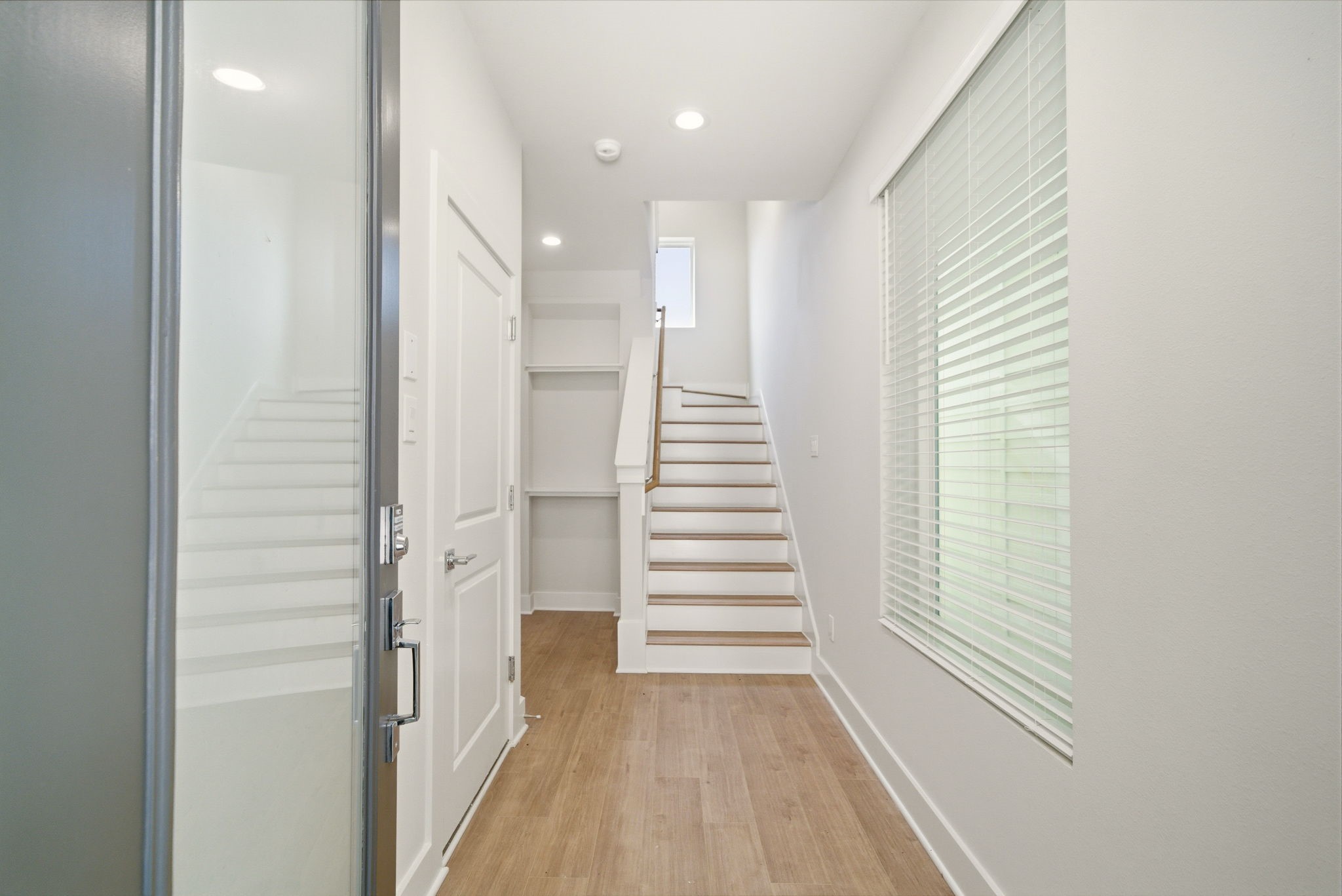 1398 Cedar Post Lane Houston, TX 77080 - Photo 4 of 33 a view of a hallway with stairs and a window