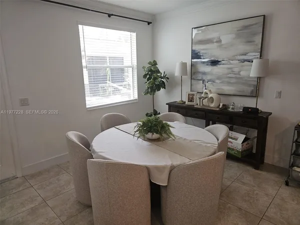 a dining room with furniture and window