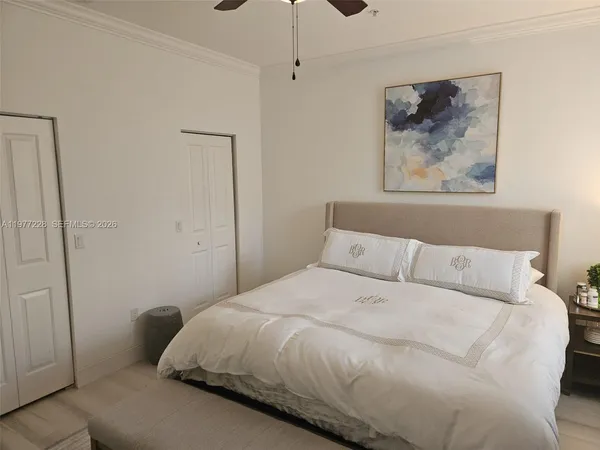 a bedroom with a bed and a painting on the wall