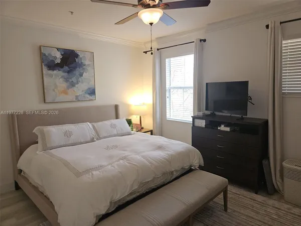 a bedroom with a bed and a flat screen tv
