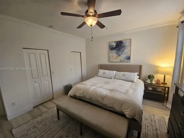 a bedroom with a bed and a chandelier