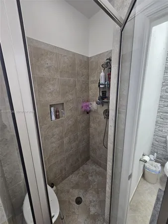 a bathroom with a shower and a sink