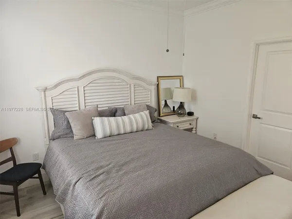 a bedroom with a bed and chair