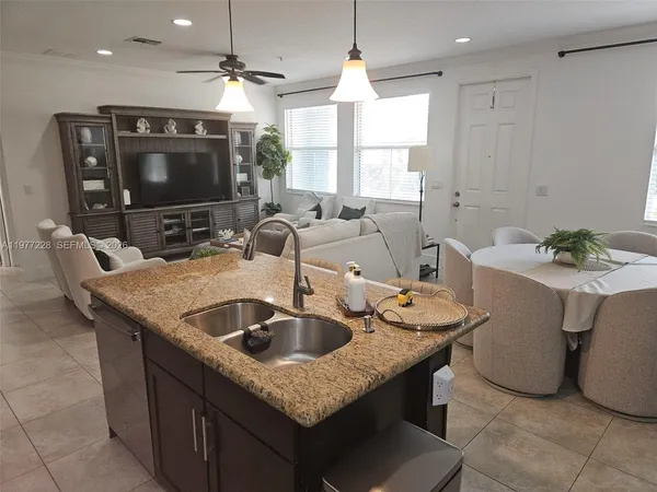 a kitchen with granite countertop a sink and a stove