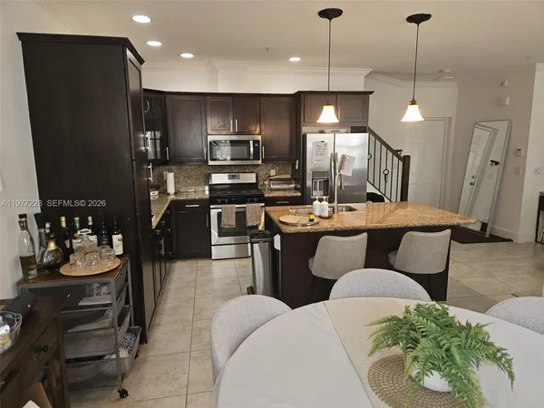 a kitchen with a refrigerator and a sink
