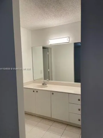 a bathroom with a glass door shower and a sink