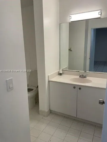 an empty room with a ceiling fan and a window