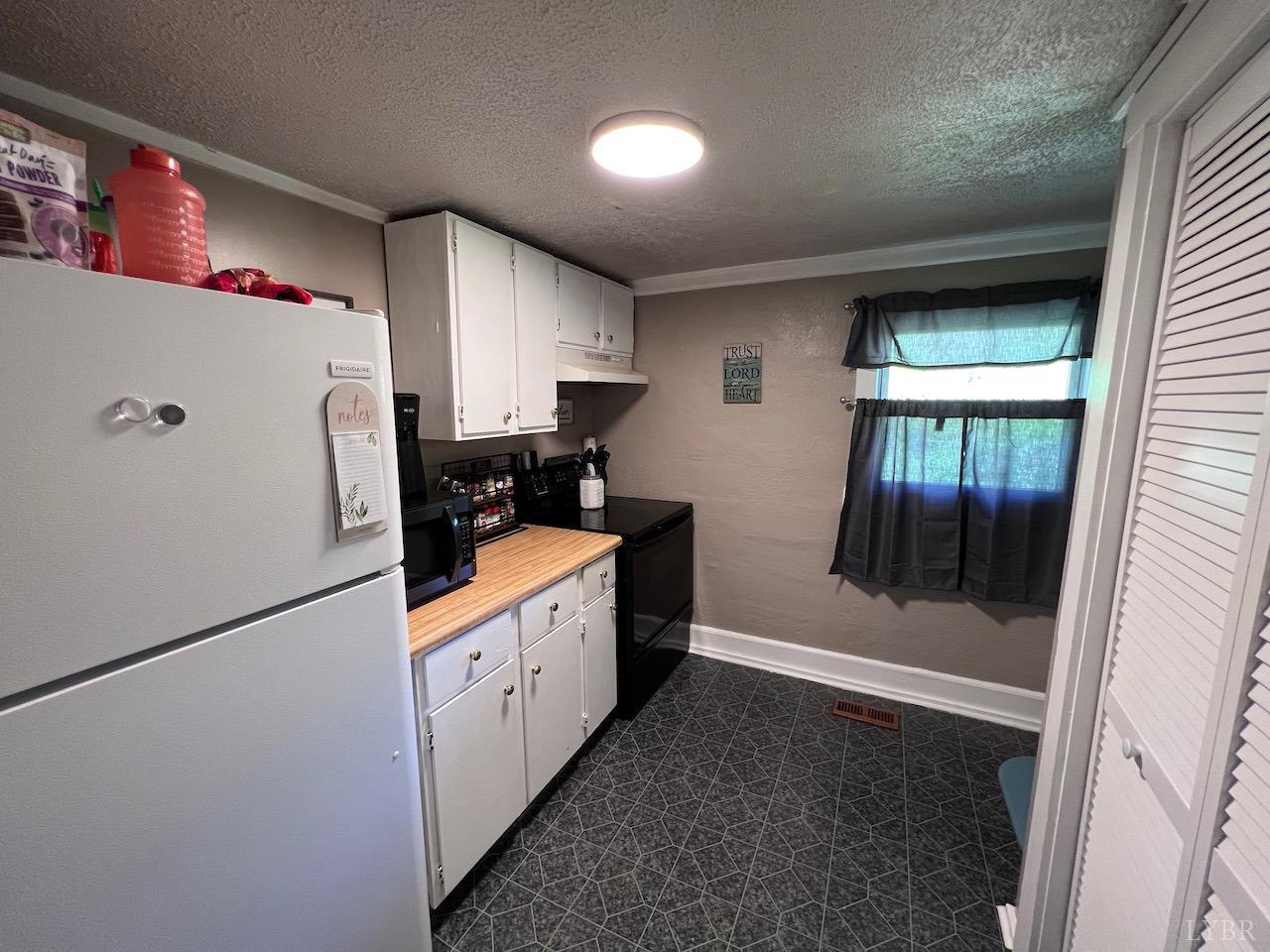 6238 Laurel Road Shipman, VA 22971 - Photo 5 of 11 a kitchen with a refrigerator a stove top oven and cabinets