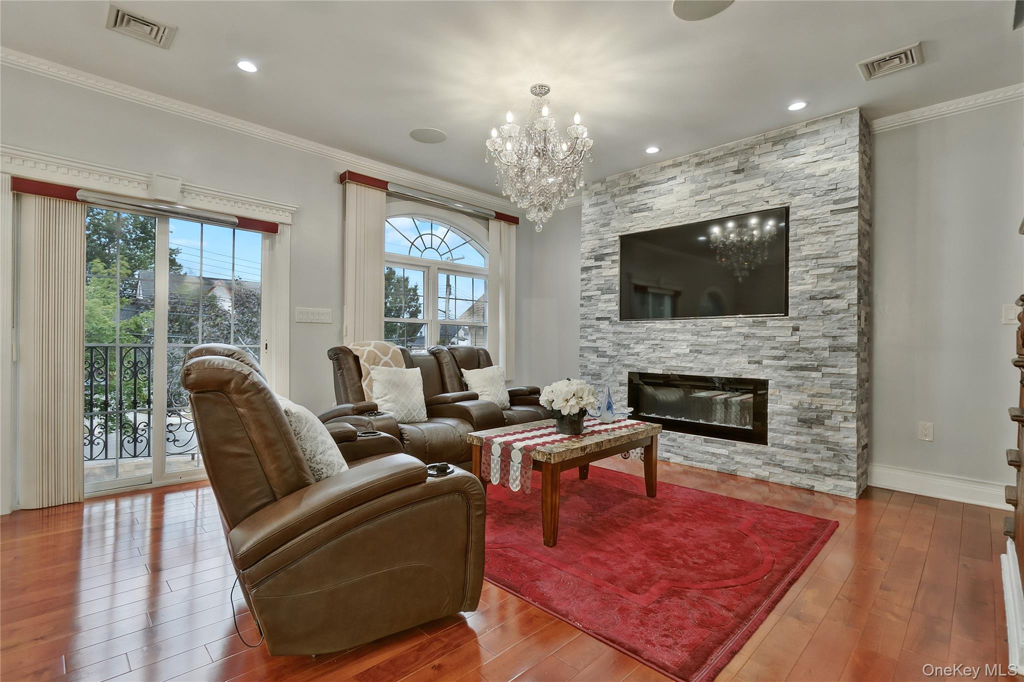 193-19 109th Road Queens, NY 11412 - Photo 12 of 27 a living room with furniture a flat screen tv and a fireplace