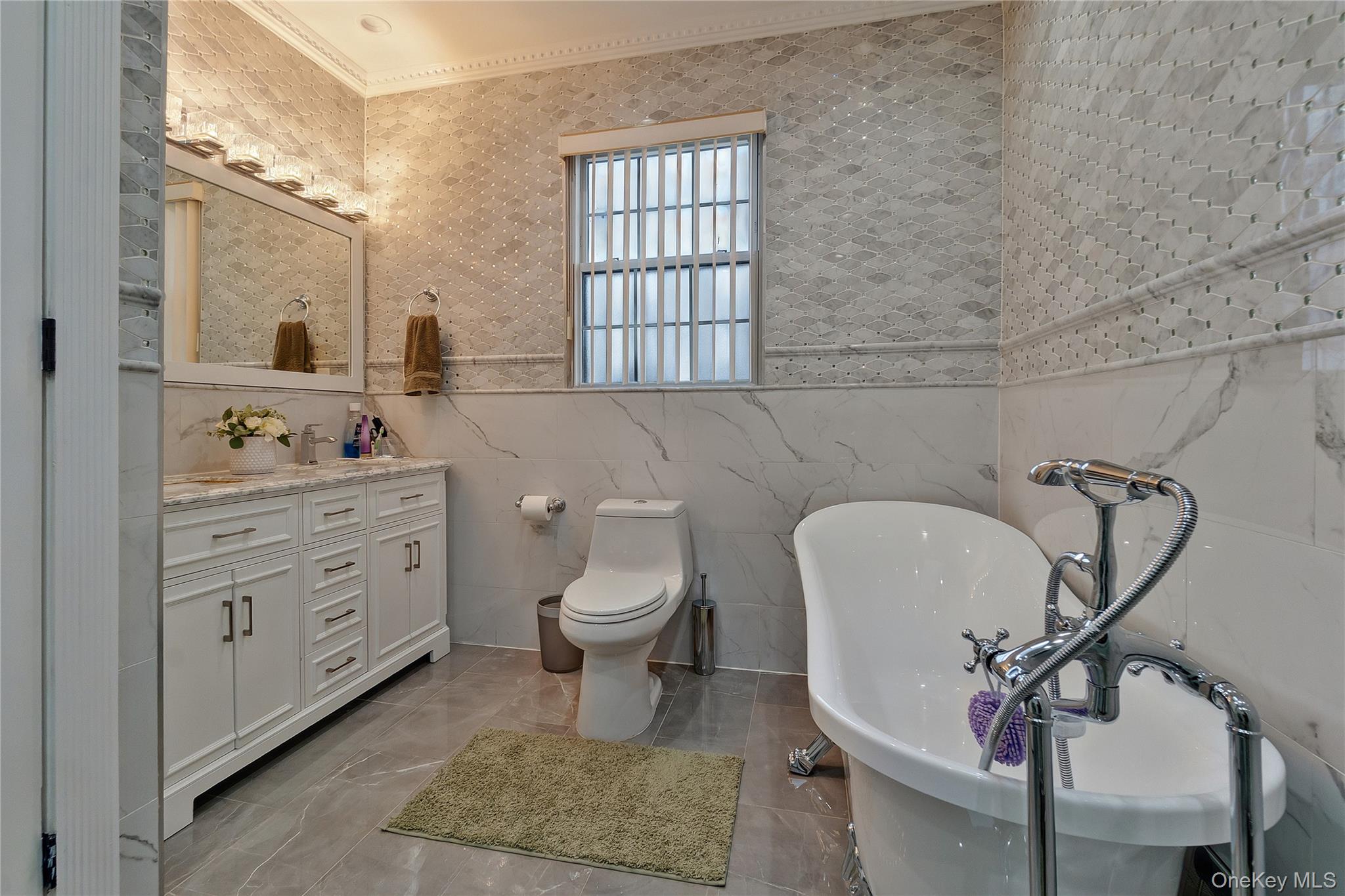 193-19 109th Road Queens, NY 11412 - Photo 22 of 27 a bathroom with a toilet a sink and mirror