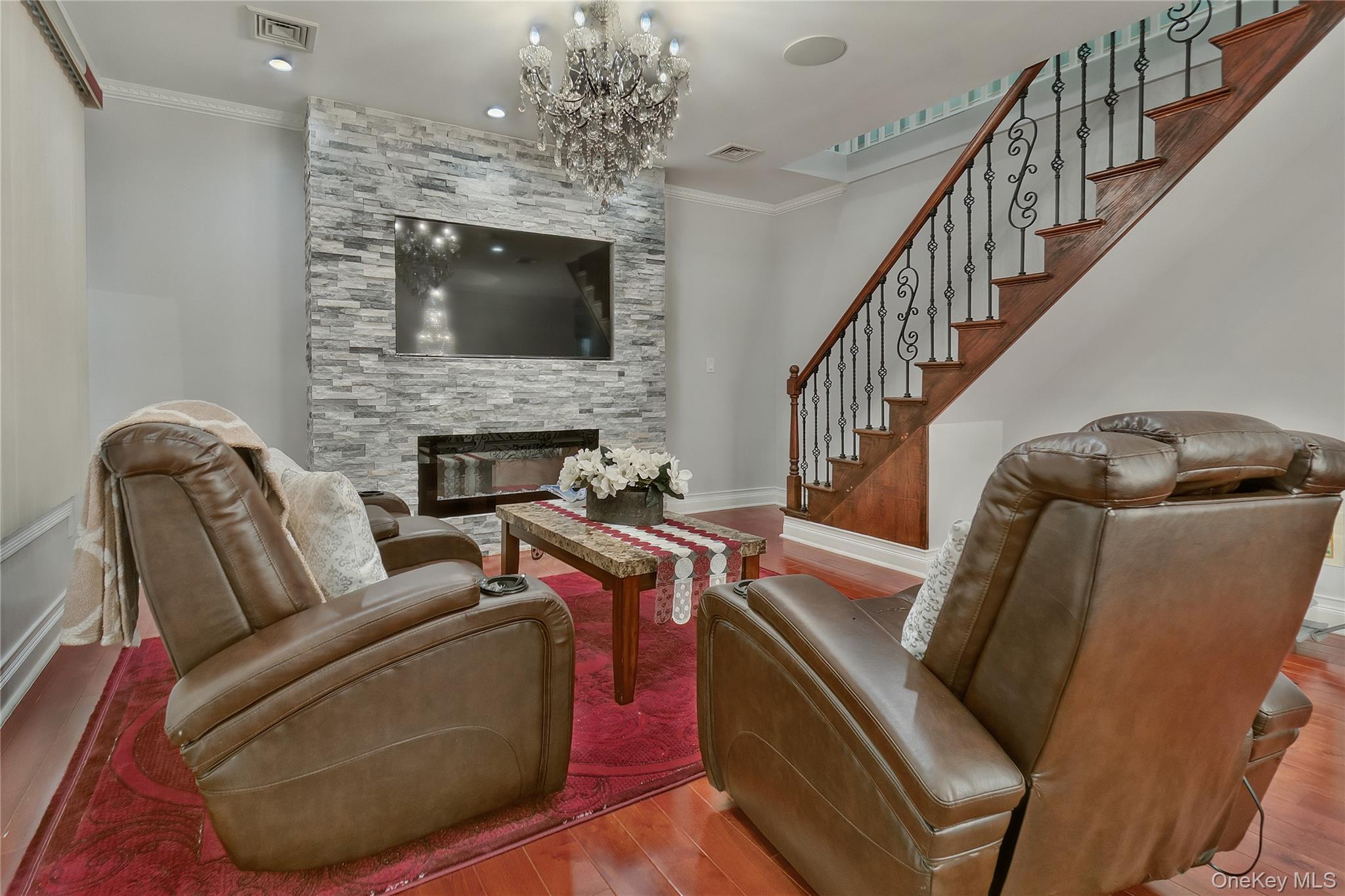 193-19 109th Road Queens, NY 11412 - Photo 23 of 27 a living room with furniture and a fireplace