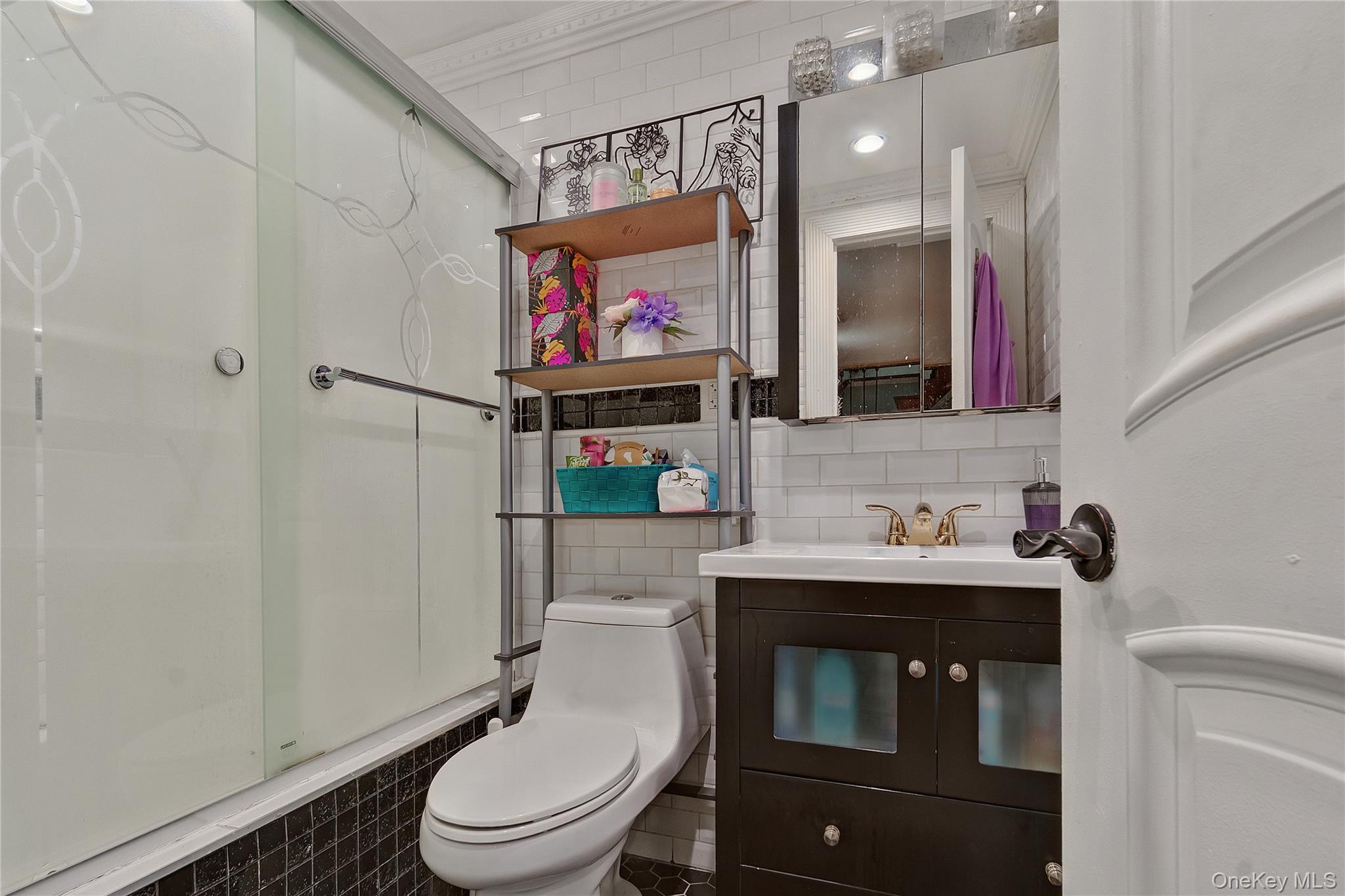 193-19 109th Road Queens, NY 11412 - Photo 25 of 27 a bathroom with a toilet sink and mirror