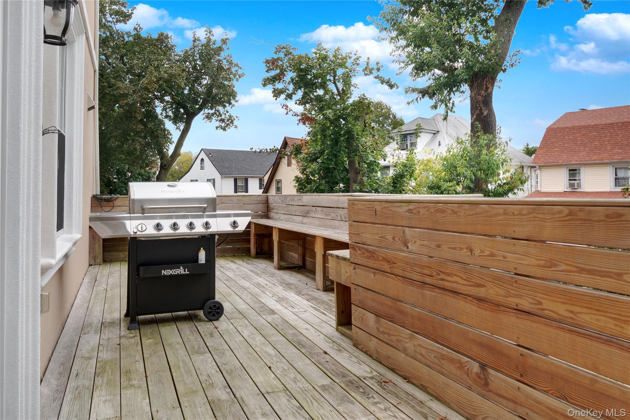 193-19 109th Road Queens, NY 11412 - Photo 27 of 27 a view of a terrace with wooden floor and fence