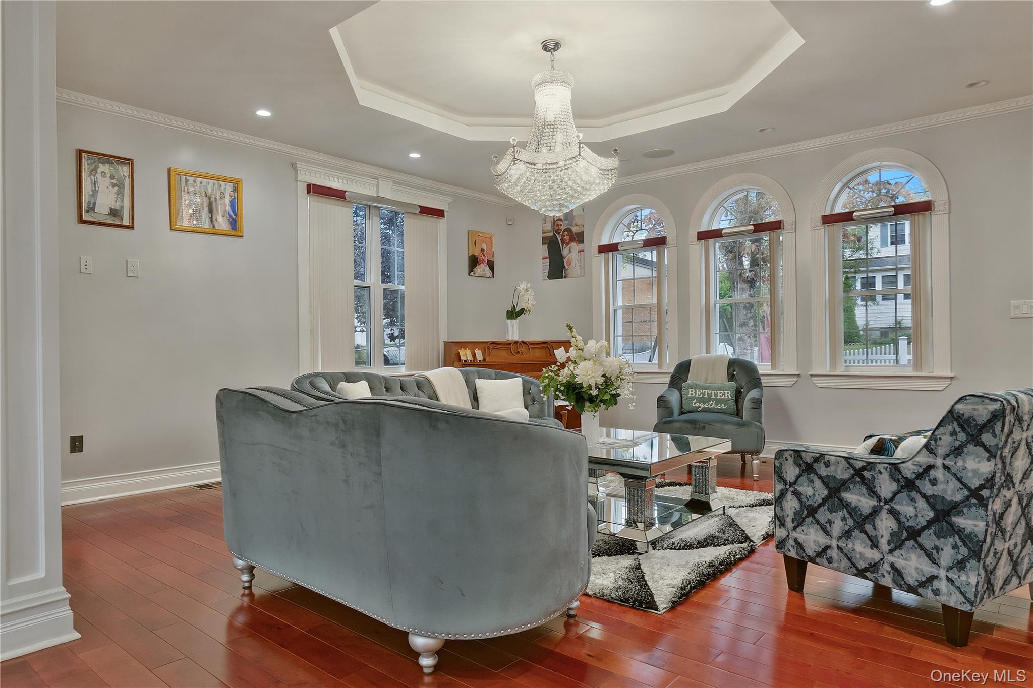 193-19 109th Road Queens, NY 11412 - Photo 6 of 27 a living room with furniture and a chandelier