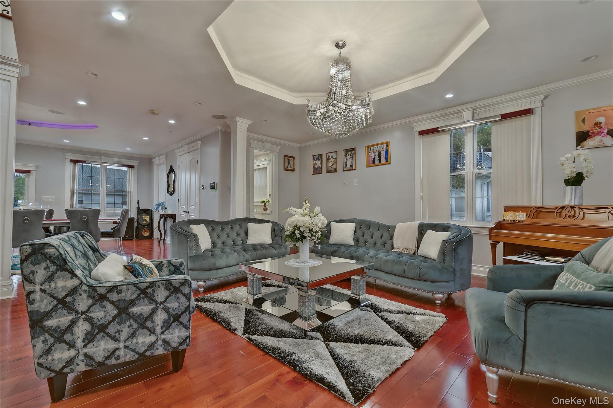 193-19 109th Road Queens, NY 11412 - Photo 7 of 27 a living room with furniture or couch and a chandelier