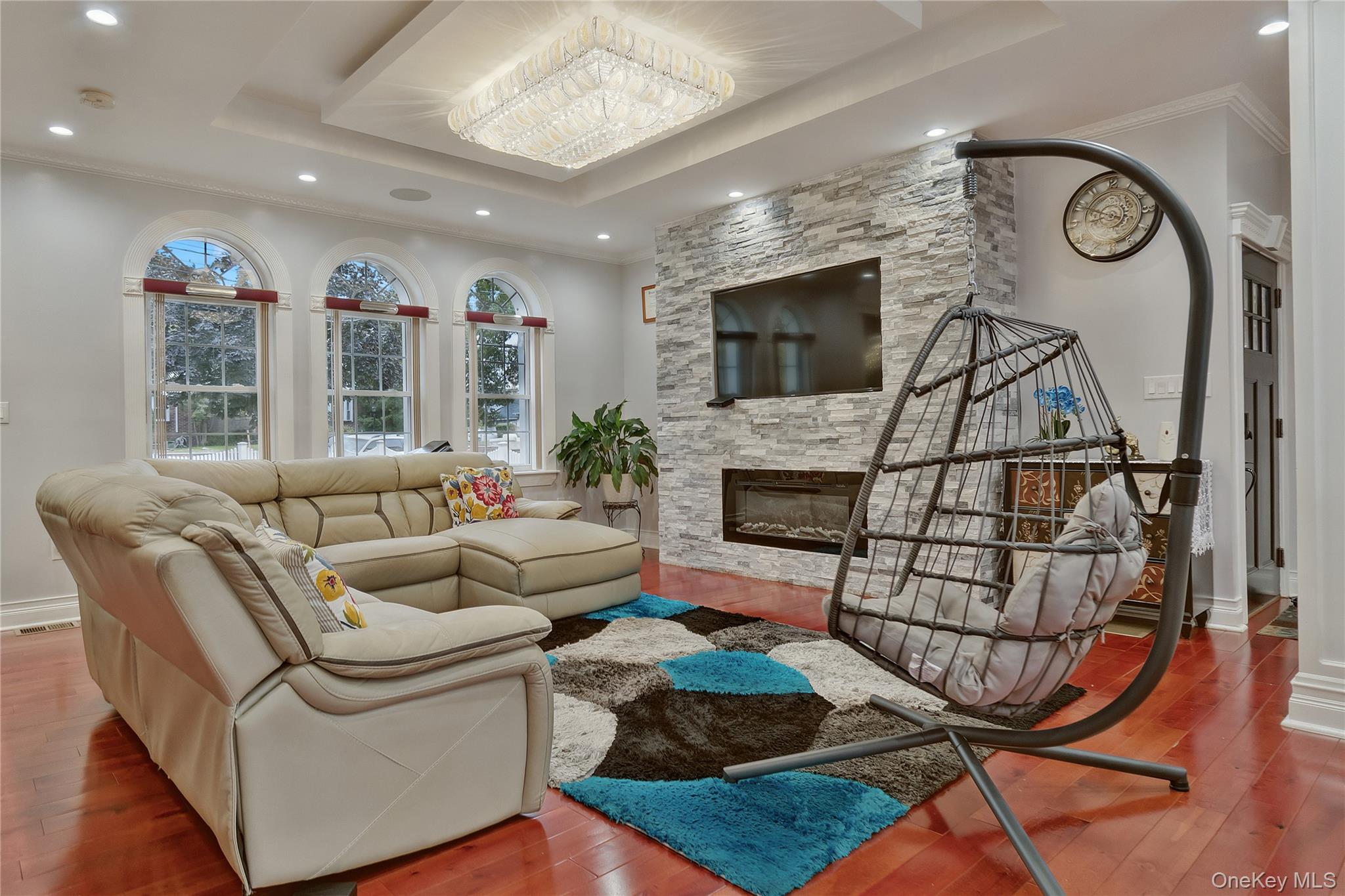 193-19 109th Road Queens, NY 11412 - Photo 8 of 27 a living room with furniture a flat screen tv and a fireplace