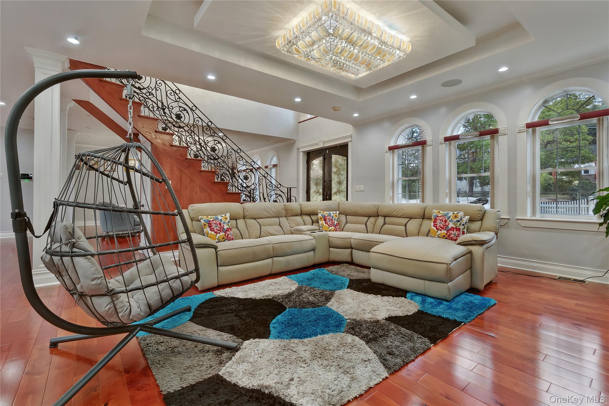 193-19 109th Road Queens, NY 11412 - Photo 9 of 27 a living room with furniture wooden floor and a chandelier
