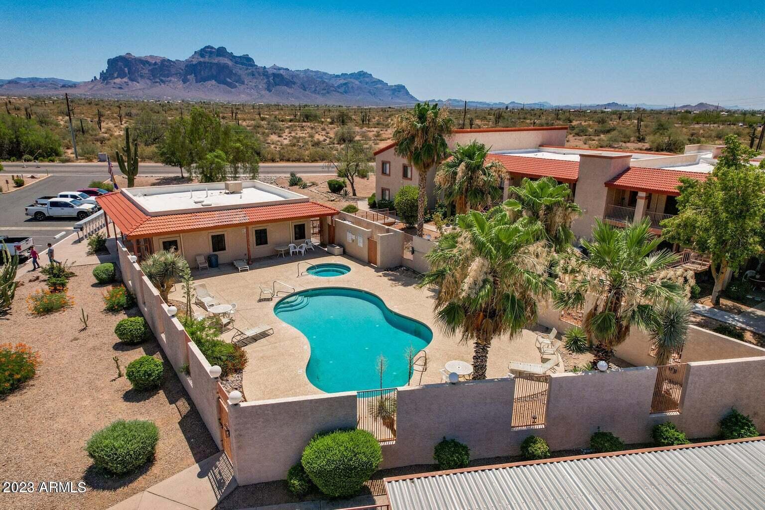 1440 North Idaho Road, Unit 1036 Apache Junction, AZ 85119 - Photo 1 of 13 an aerial view of a house with a swimming pool outdoor seating and yard
