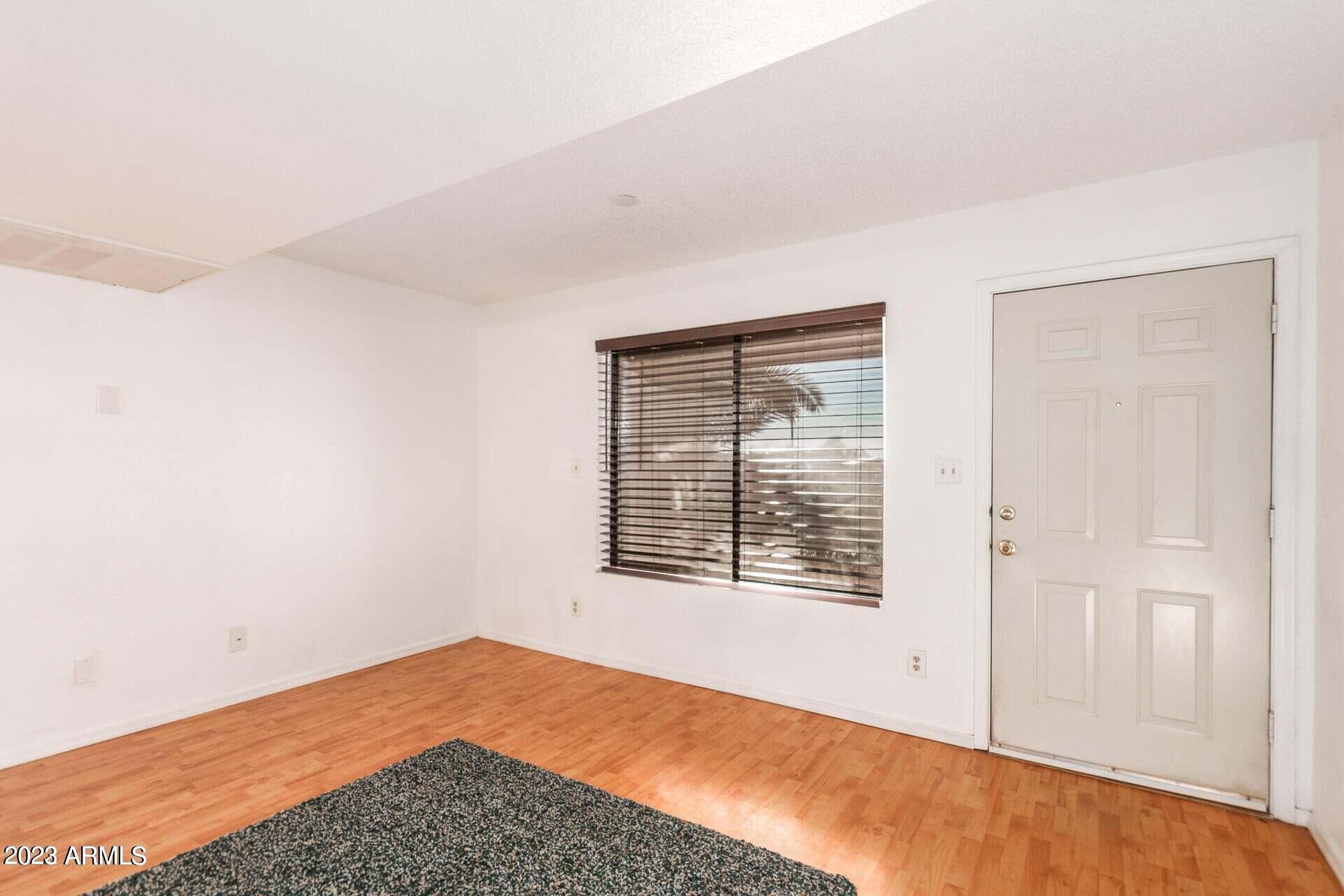 1440 North Idaho Road, Unit 1036 Apache Junction, AZ 85119 - Photo 3 of 13 a view of an empty room with a window