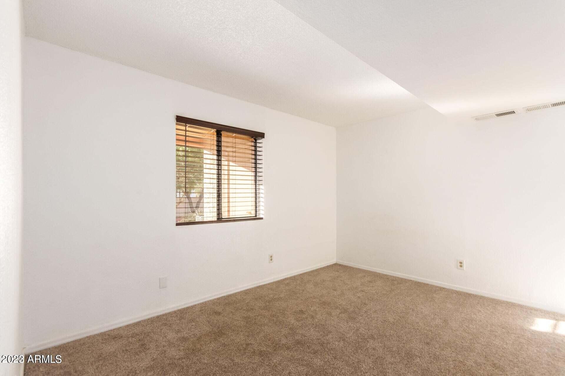 1440 North Idaho Road, Unit 1036 Apache Junction, AZ 85119 - Photo 7 of 13 an empty room with a window