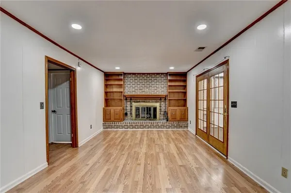 wooden floor in an empty room with a fireplace