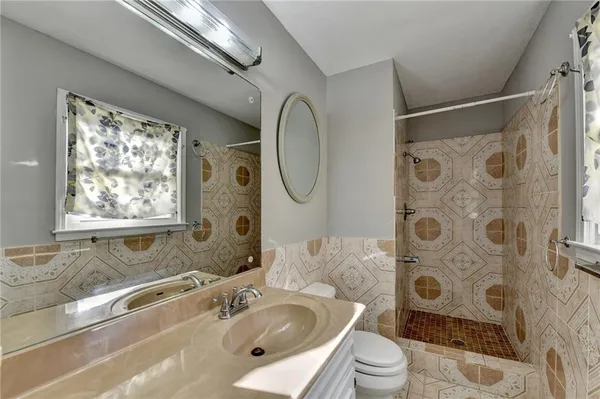 a bathroom with a sink toilet and shower